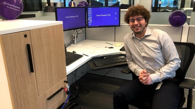 StFX co-op student at desk with computer